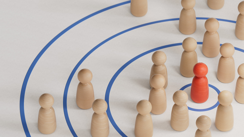 Wooden figures arranged around a highlighted candidate in a target circle